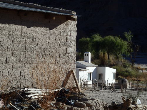 Adobe structures on a roadside farm.